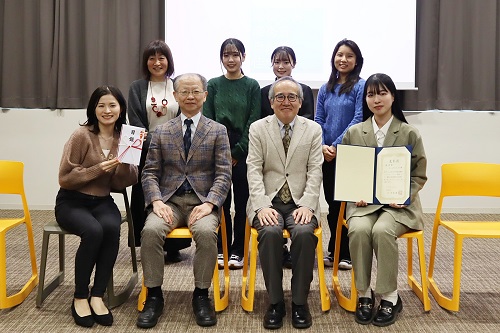 杉本学長（前列中央右）、上野副学長（前列中央左）と優秀賞の「チームアムちゃん」メンバーと都築副学長（後列左）